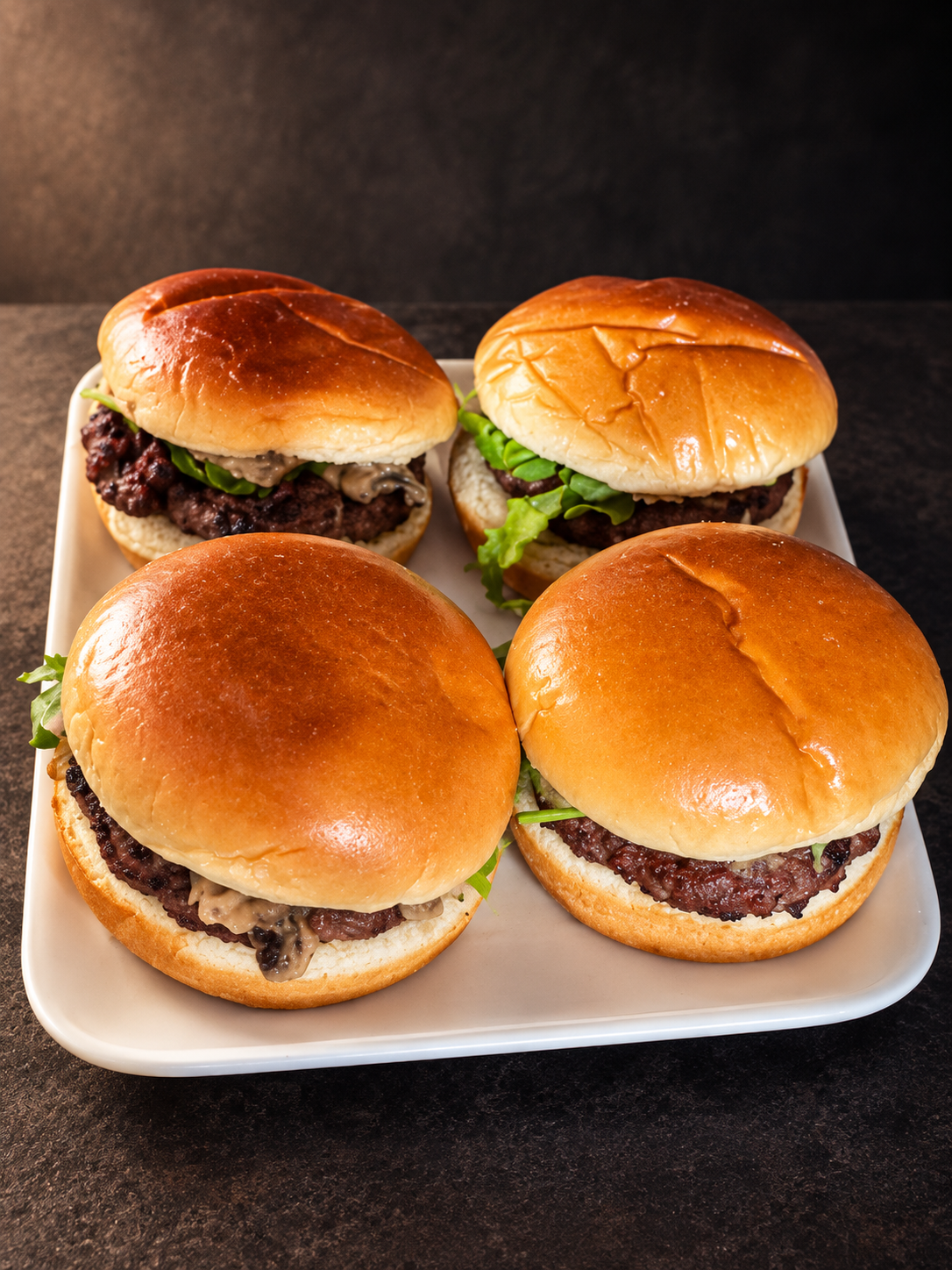 Four Al Aweer burgers with golden buns